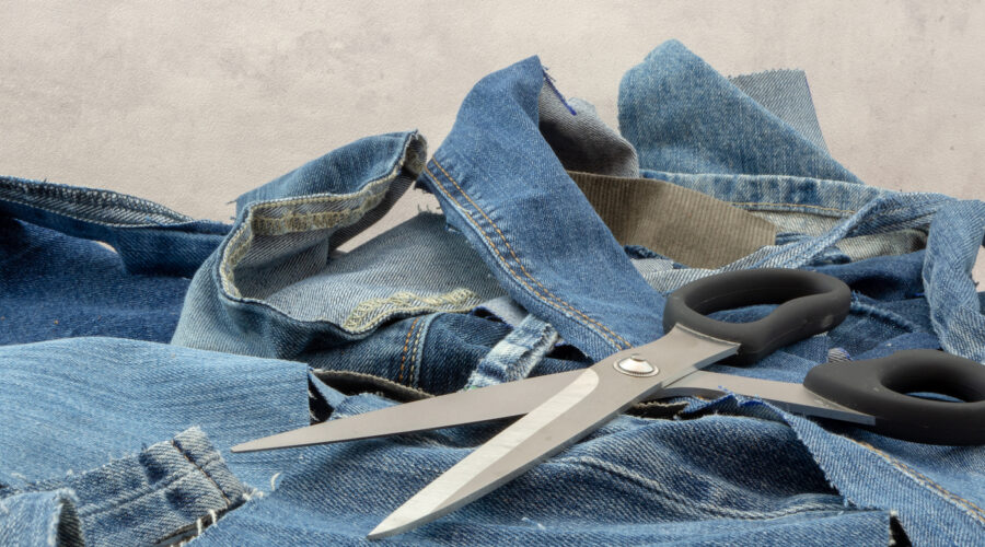 Jeans, ready to be recycled. Scraps of old discarded jeans can start a new life. Circular economy, reduce, reuse recycle.